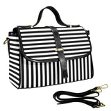 Black and white striped handbag designed by Alternawear with a detachable strap on a white background