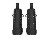 Black rain boots with white polka dots on a white background