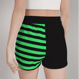 rear shot of a model wearing black shorts with mismatched green striped print on the right-hand side 
