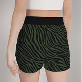 Black shorts with green zebra print all over, reverse of product on model