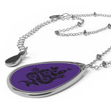 A side on view of the Black tribal snake on a purple background by Alternawear connected with. a silver looking chain