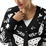 Close-up_of_celestial_snake_jacquard_knit_design_on_soft_black_cardigan_showing_detailed_texture_and_print.