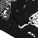 Close-up_of_cuff_and_buttons_celestial_snake_jacquard_knit_design_on_soft_black_cardigan_showing_detailed_texture_and_print.