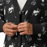 closeup of a lady holding her buttons wearing doodle tattoo black and white cardigan alternative