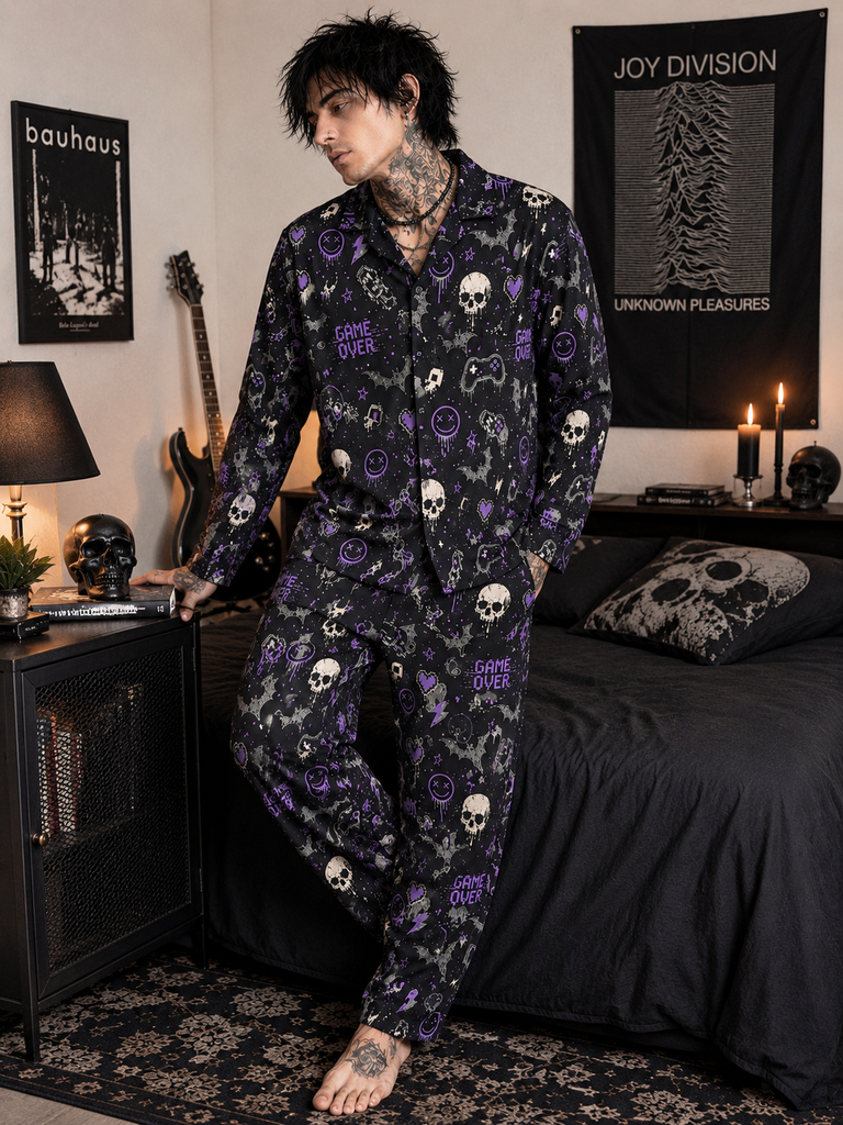 Person wearing a dark pajama set with skull patterns in a bedroom setting.
