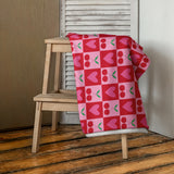 checkered cherry and heart print rockabilly style towel folded on a stool