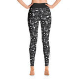 rear angle of model wearing black leggings that have a classic tattoo print including skulls, anchors, swallows & hearts