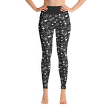 front on shot of model wearing black gym leggings with a classic white tattoo print including skulls, hearts, dice, anchors and swallows